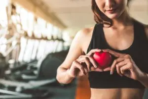 happy woman holding red heart